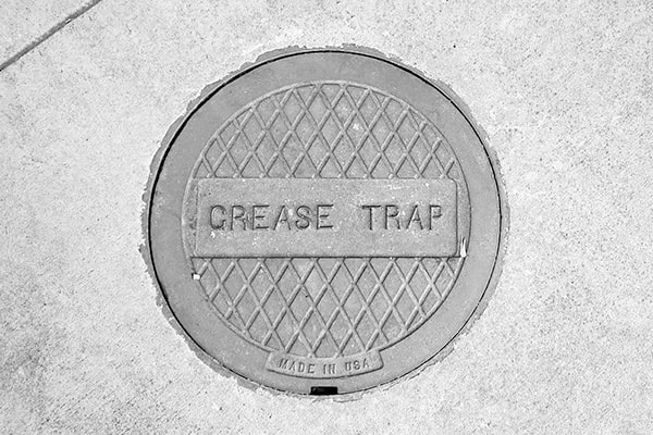 during grease trap pumping, a vacuum truck is used to remove the buildup of grease and solids from the trap